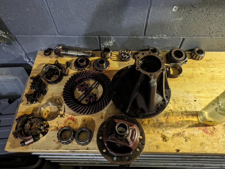 Component pieces of fully-disassemble differential on workbench