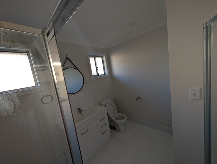 First overall shot of bathroom aimed at back-right corner